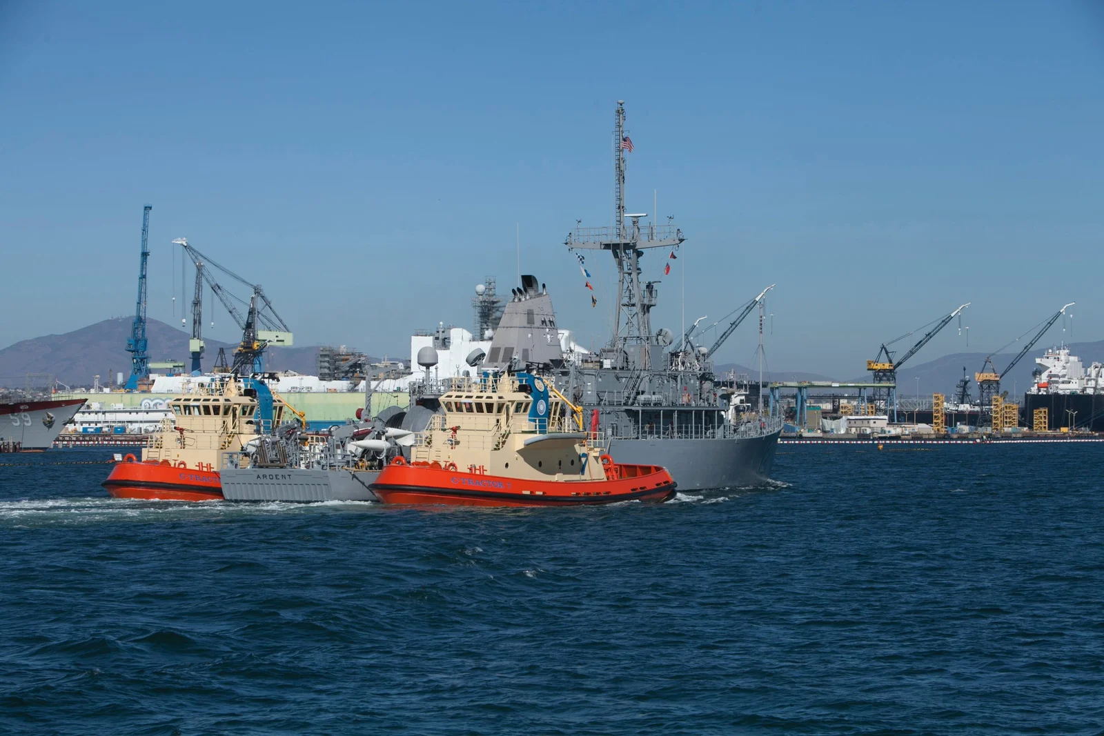 Working harbor with tugs and commercial vessels